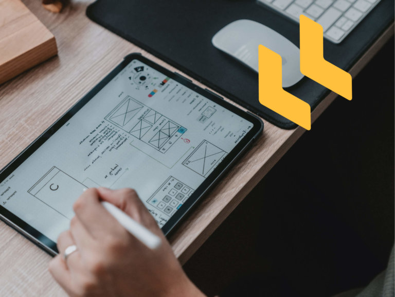 person designing wireframes on tablet