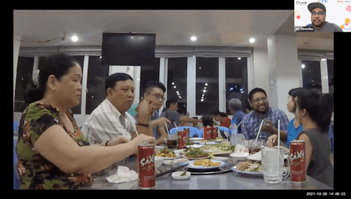An image of a group of locals talking to Grab's UX team over a meal