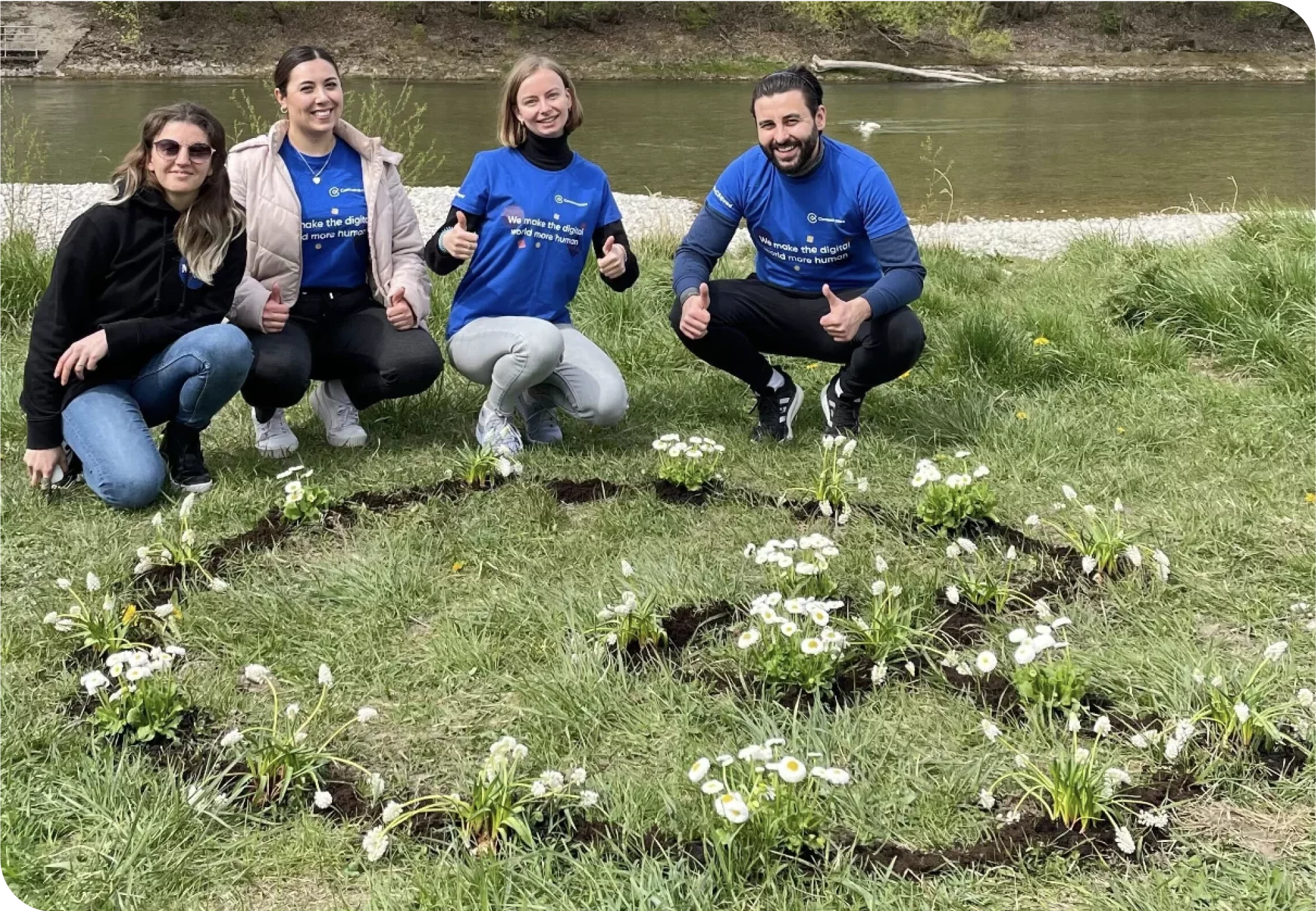 our german team planting flowers in the shape of our logo